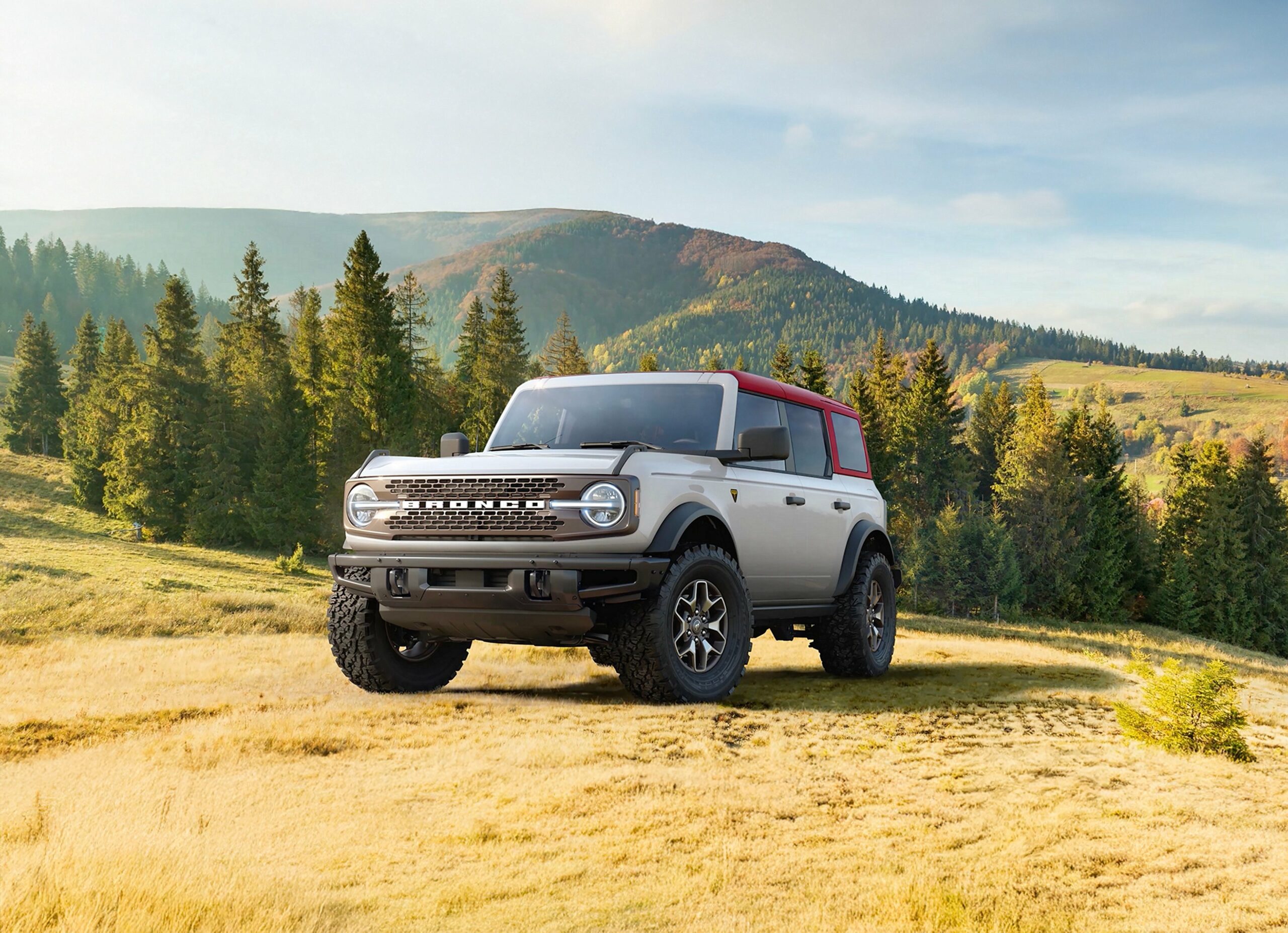 A 2026 Ford Bronco in open grassland below mountains