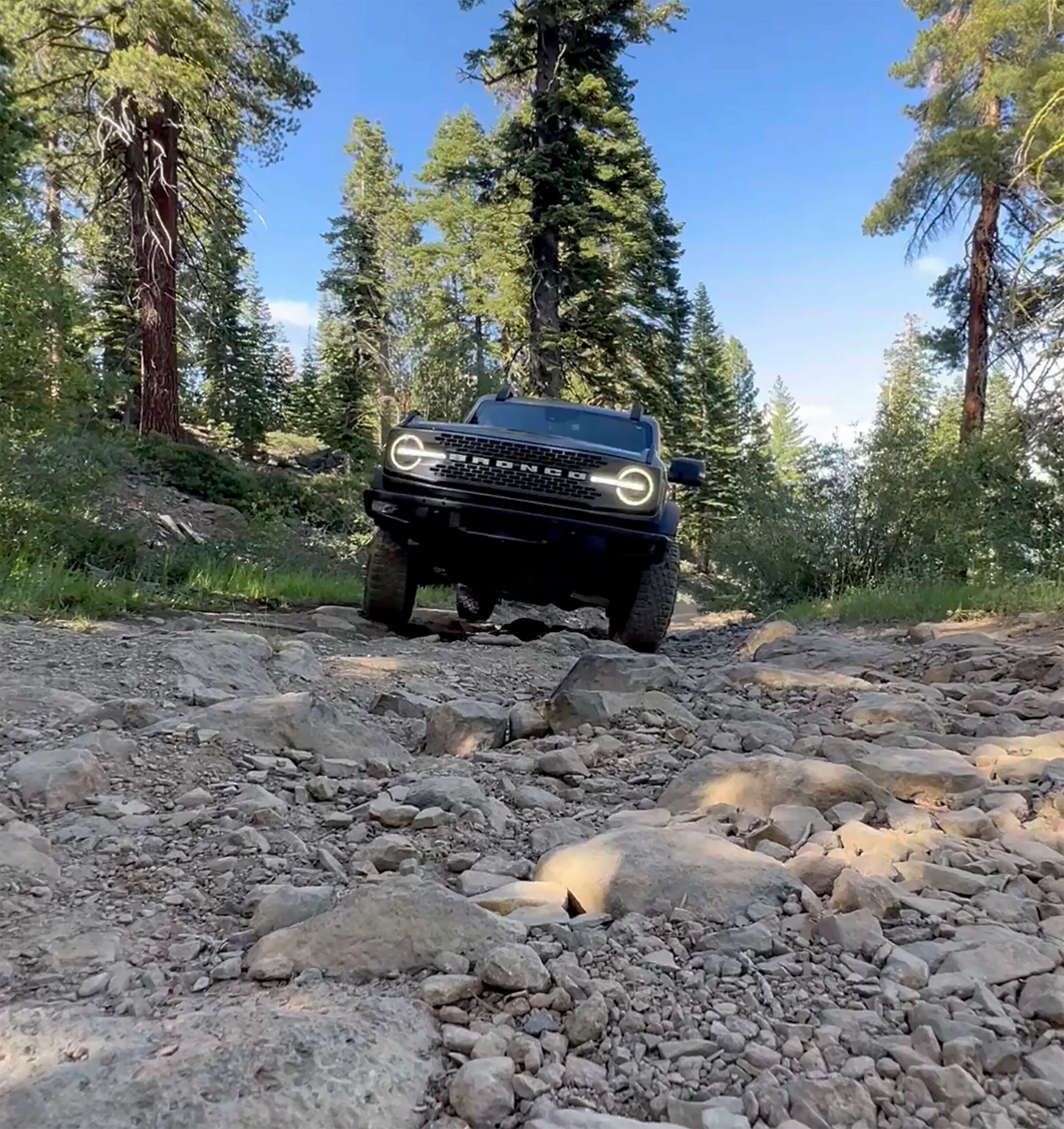 A 2026 Ford Bronco climbing a rocky creek bed