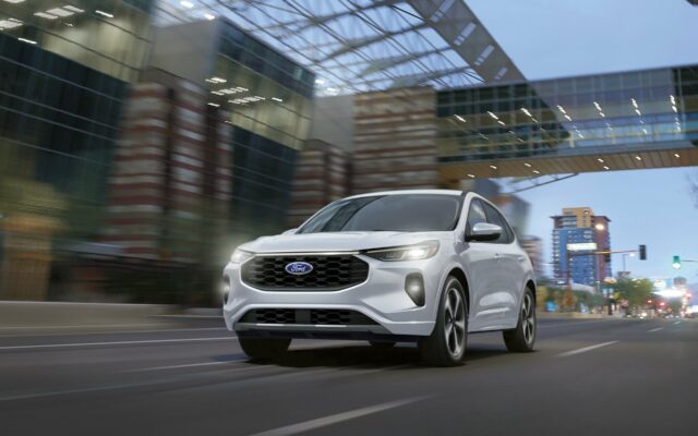A white 2026 Ford Escape driving under a bridge